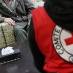 Two people sitting in front of ICRC staff